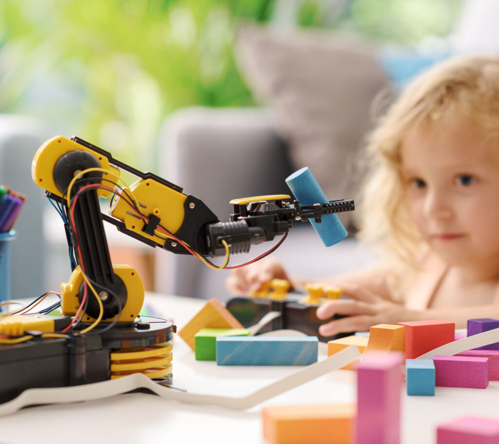 child playing with a robotic arm