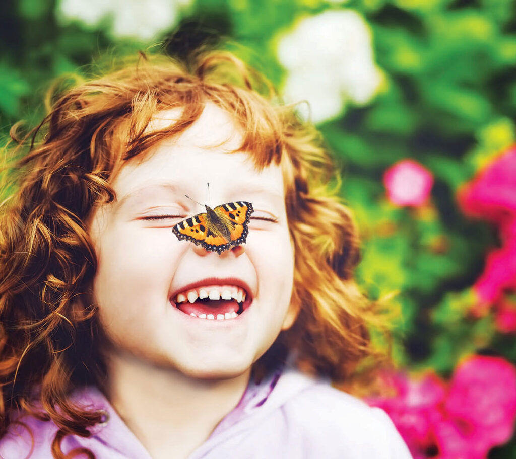 child with butterfly on nose